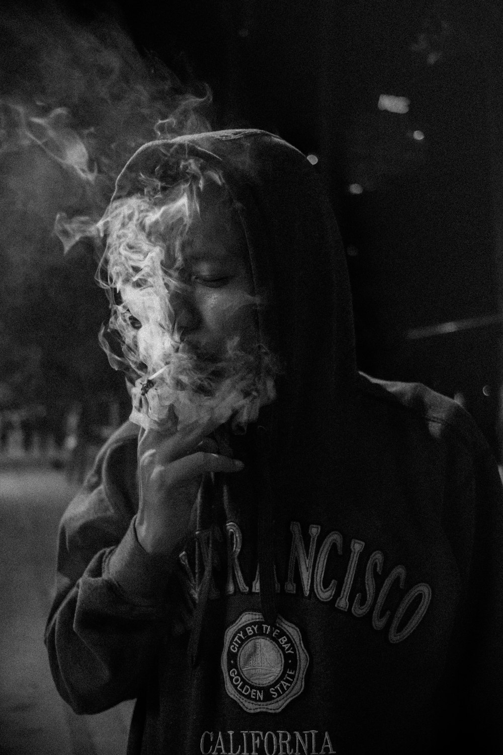 grayscale photography of man smoking