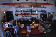 A cozy corner of the café with vintage décor and customers enjoying their drinks and conversations.