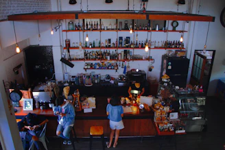 A cozy corner of the café with vintage décor and customers enjoying their drinks and conversations.