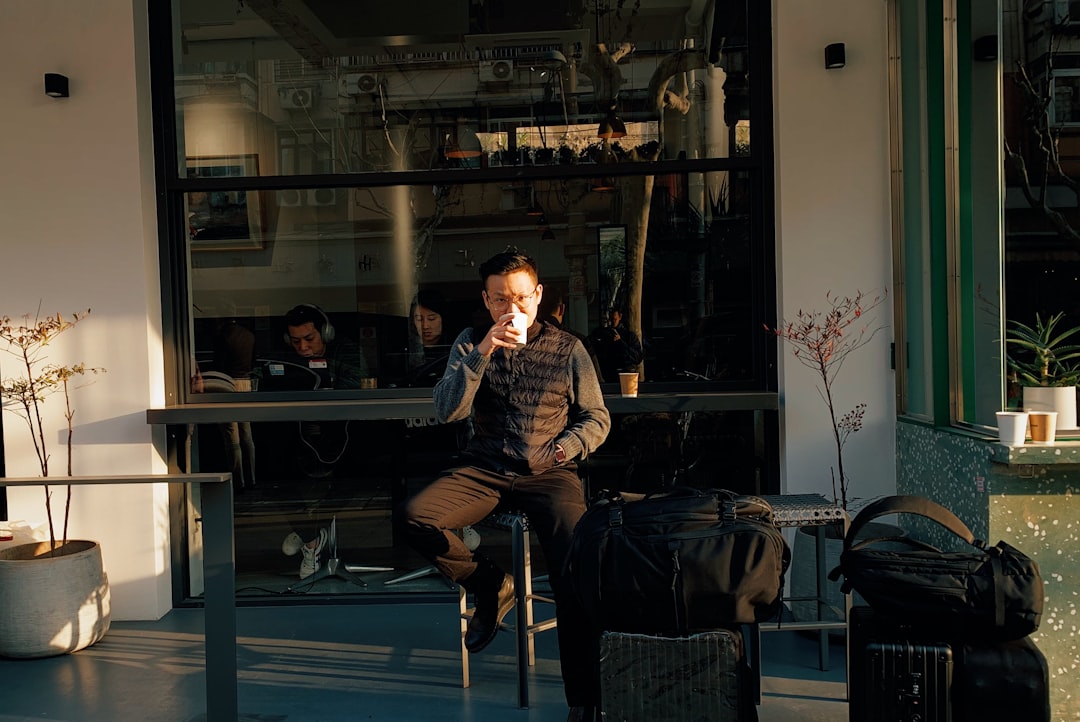 man sitting on stool during daytime