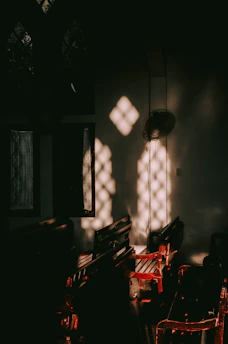 Sunlight filtering through carved wooden screens in a serene riad room.