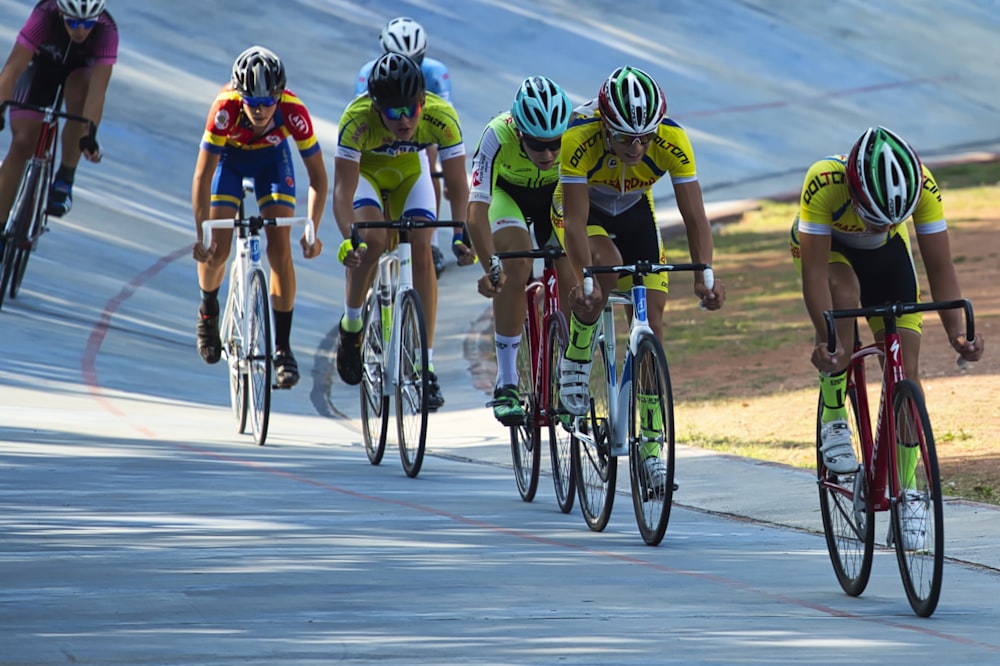 men riding road bike during daytime