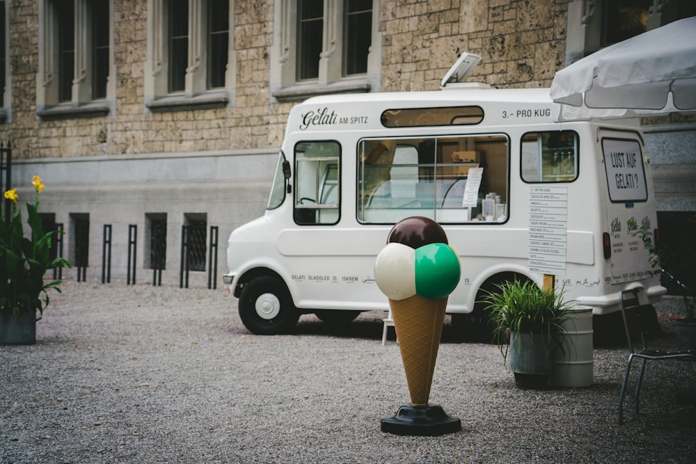 white vehicle beside brown concrete building