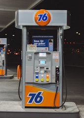 gray and orange gasoline pump