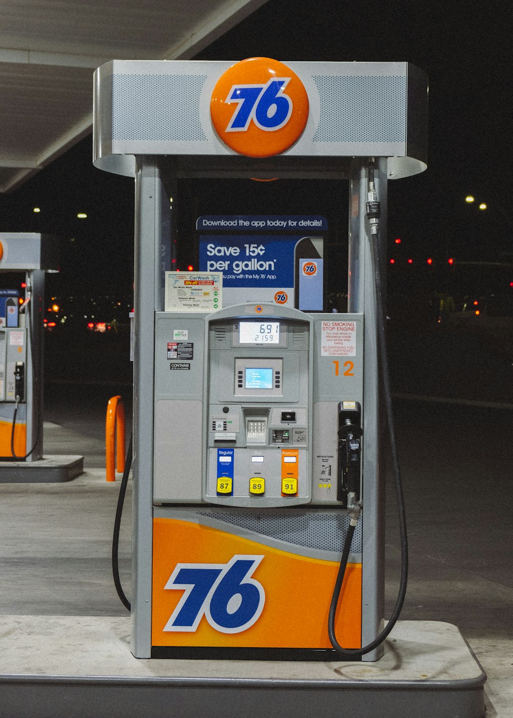 gray and orange gasoline pump