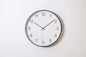 round analog wall clock pointing at 10:09