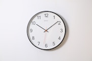 round analog wall clock pointing at 10:09