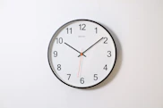 round analog wall clock pointing at 10:09