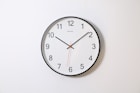 round analog wall clock pointing at 10:09