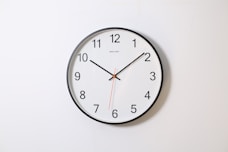 round analog wall clock pointing at 10:09