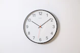 round analog wall clock pointing at 10:09
