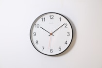 round analog wall clock pointing at 10:09