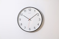 round analog wall clock pointing at 10:09