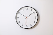 round analog wall clock pointing at 10:09