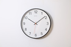 round analog wall clock pointing at 10:09
