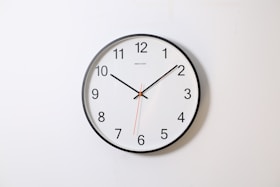 round analog wall clock pointing at 10:09