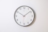 round analog wall clock pointing at 10:09