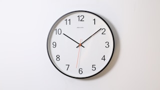 round analog wall clock pointing at 10:09