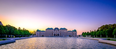 A grand palace courtyard bathed in golden sunset light, evoking regal splendor.