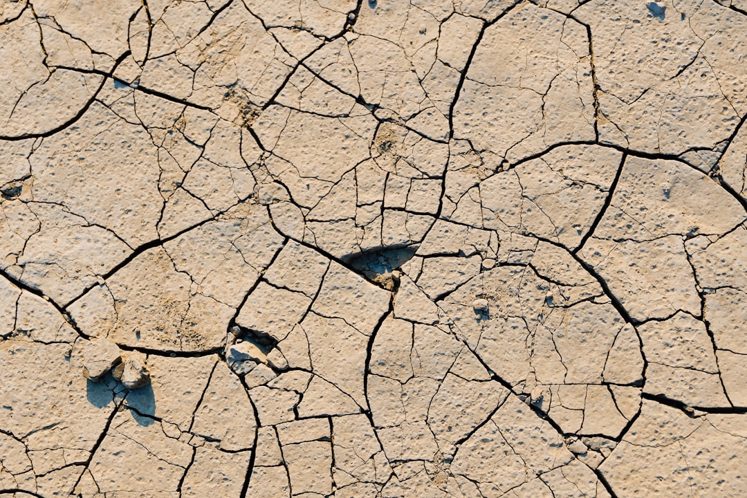 Cracked, dry reservoir bed illustrating water scarcity - water management solutions Cracked, dry reservoir bed illustrating water scarcity - water management solutions