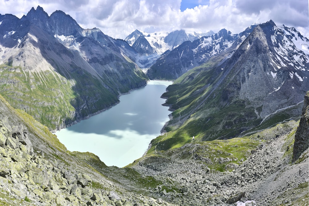 aerial photography of lake between mountain range during daytime