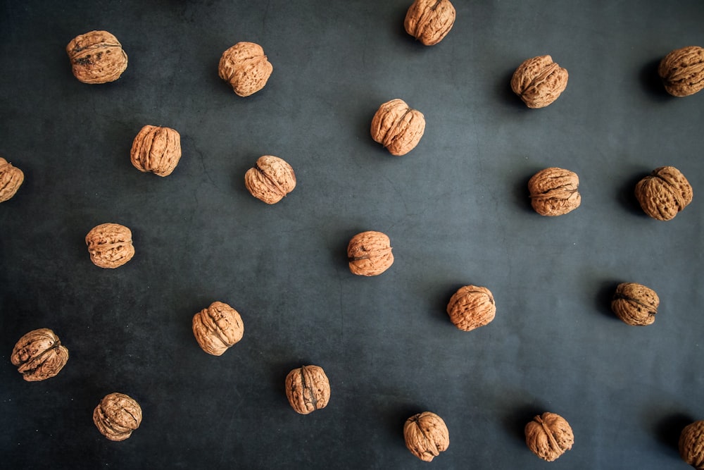 a bunch of walnuts on a black surface