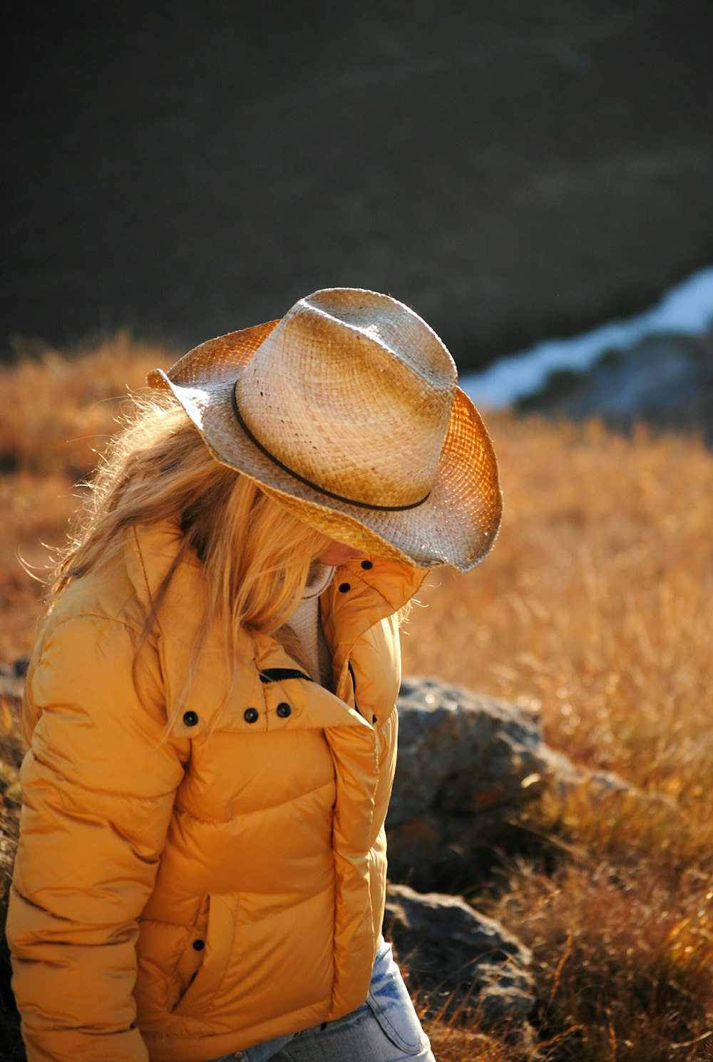 woman wearing yellow bubble jacket close-up photography