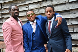 three men standing next to each other