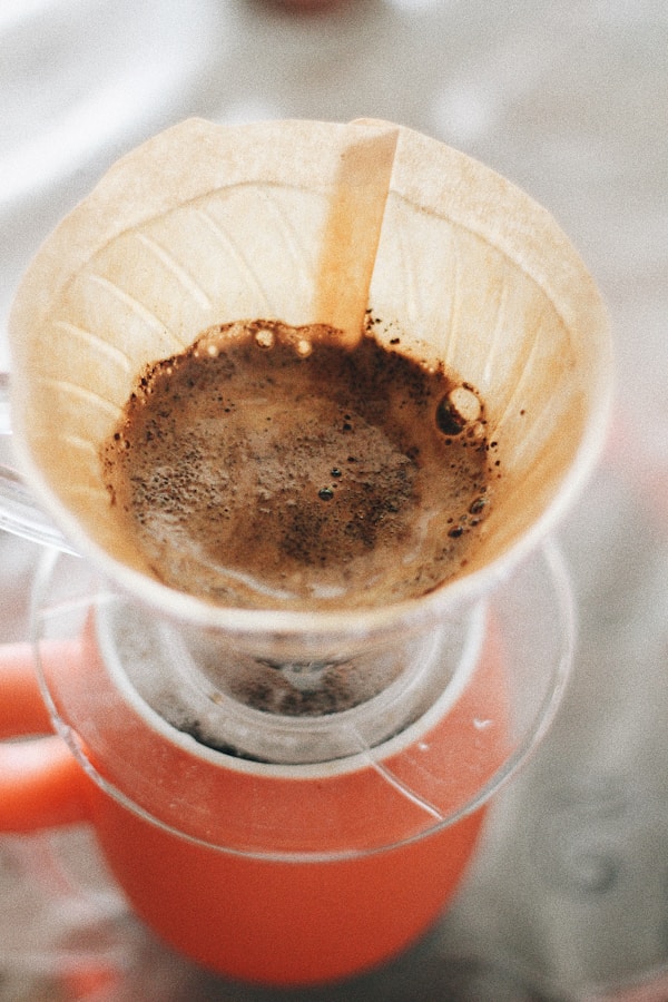 Round white funnel with brown liquid