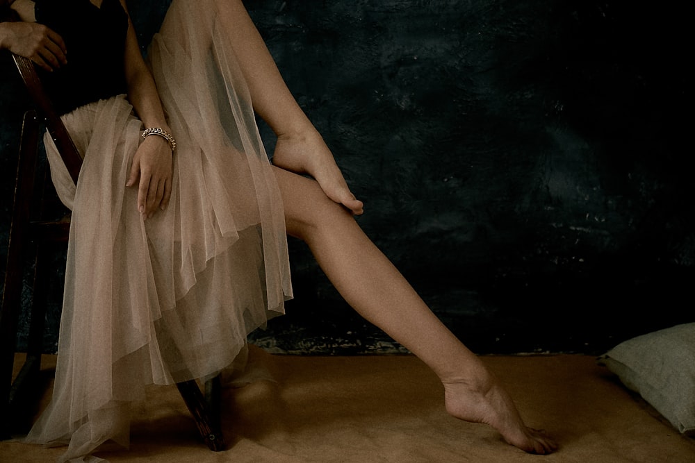 a woman sitting on a chair with her legs crossed