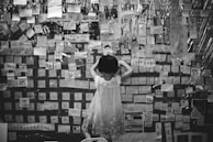 black and white photo of girl in white short-sleeved dress