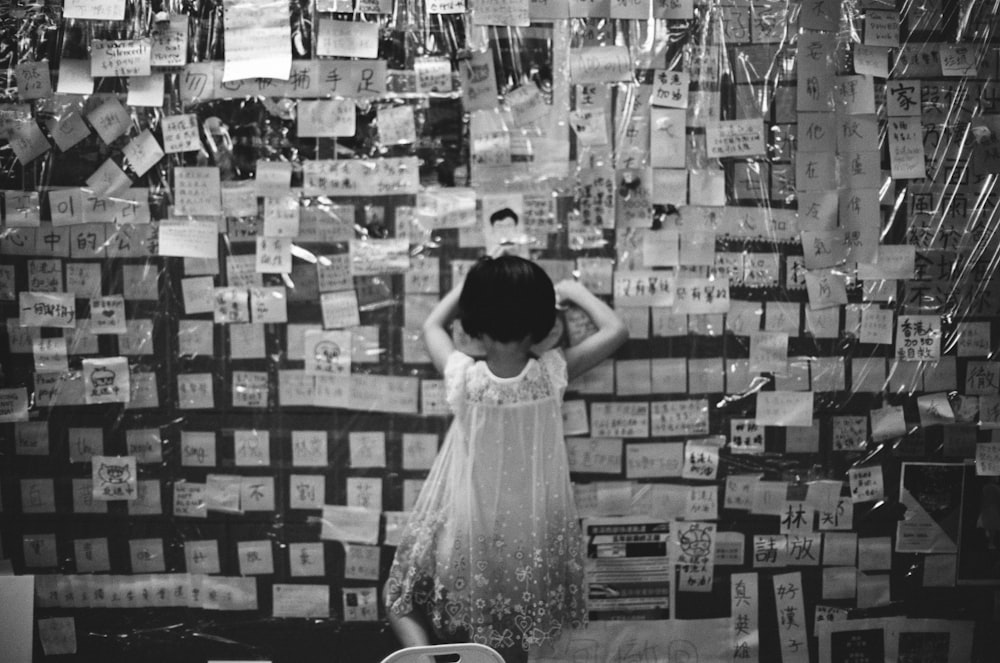 black and white photo of girl in white short-sleeved dress