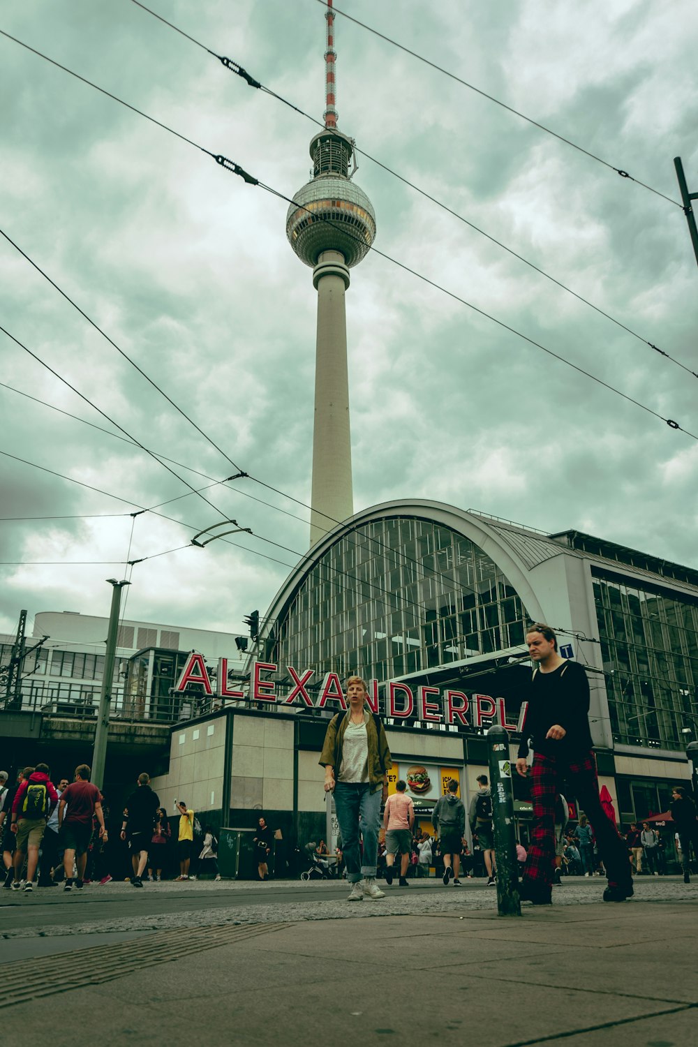 a group of people standing in front of a tall building