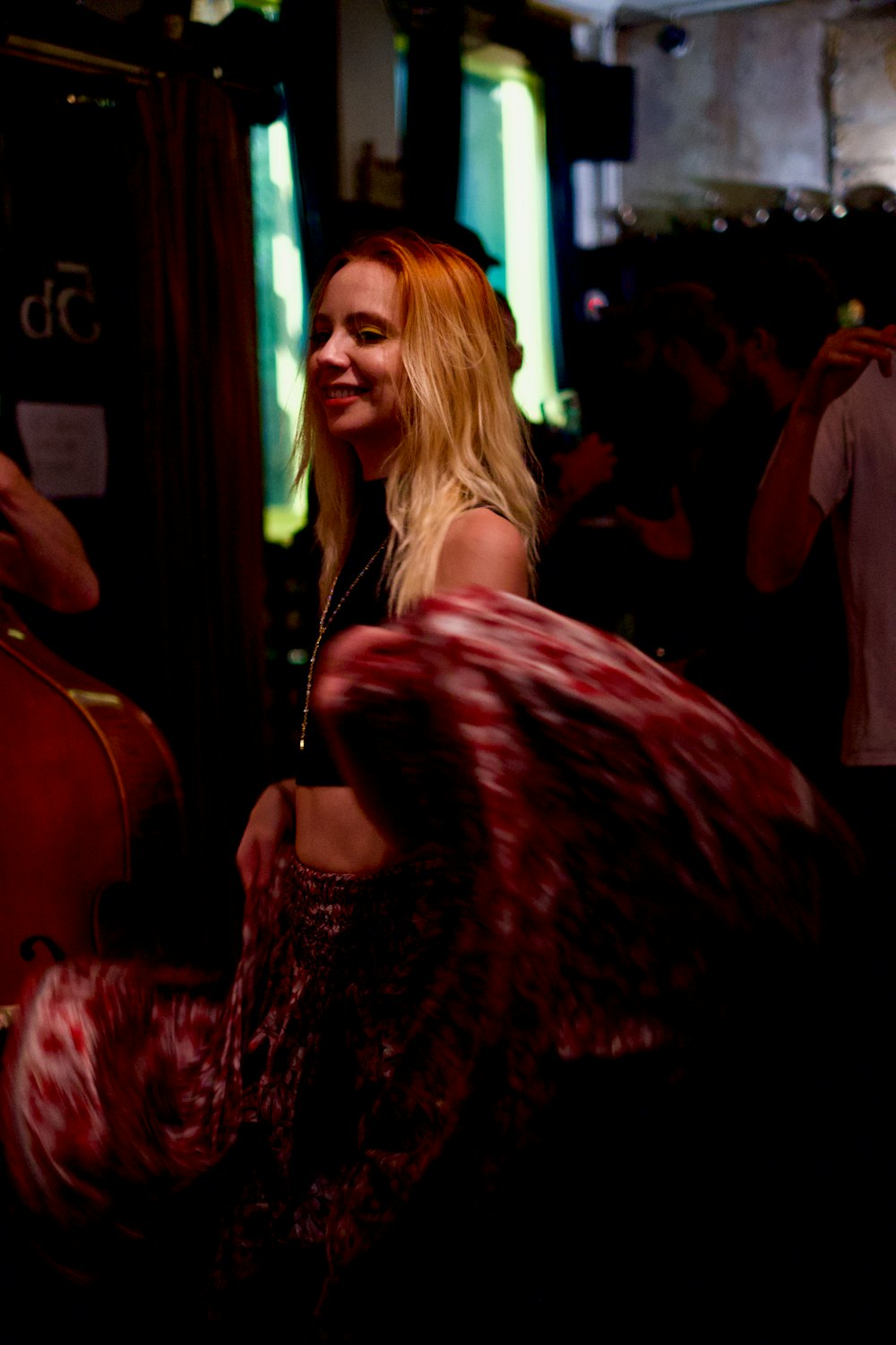 a woman standing next to a man in a bar