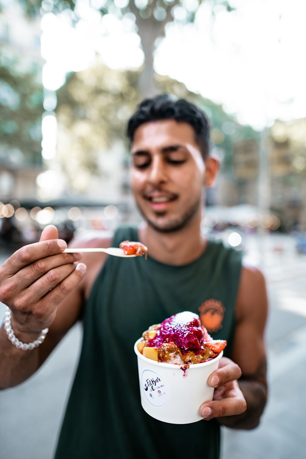 man holding cup of food