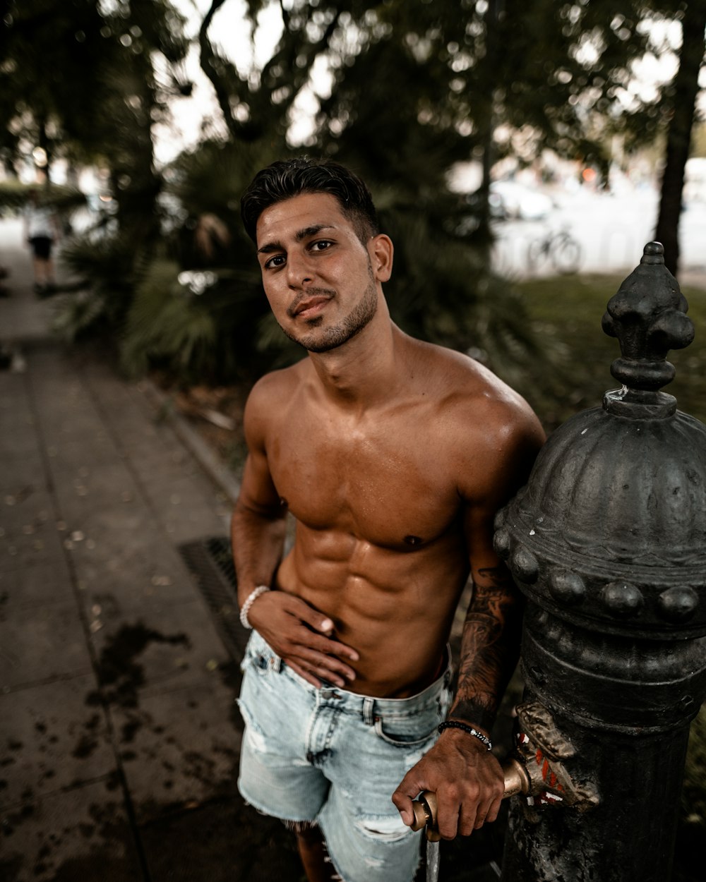 topless man wearing blue denim shorts