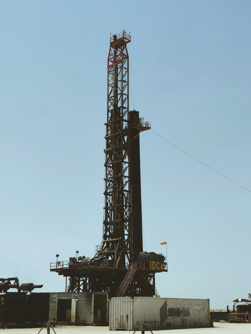 an oil rig sitting in the middle of a field