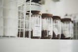 Rows of glass jars filled with ethically sourced coffee beans on shelves.