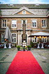 a red carpet is on the ground in front of a large building