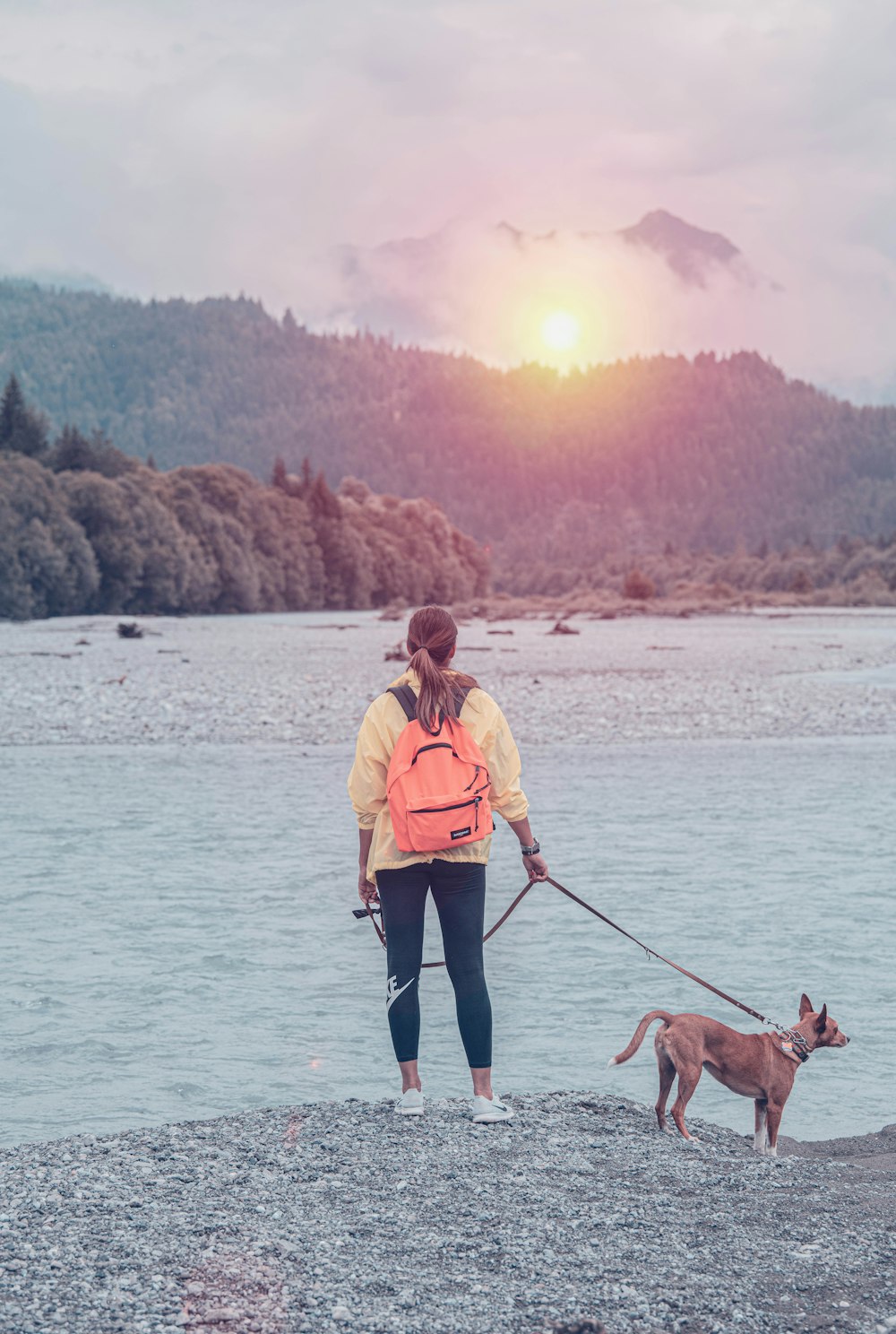 woman with dog near river