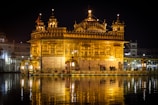 Golden temple architecture in Varanasi, glowing warmly at dusk along the riverbank.