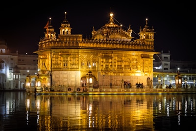 Golden temple architecture in Varanasi, glowing warmly at dusk along the riverbank.