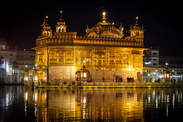 A serene temple courtyard bathed in soft golden light at dawn, with diya lamps glowing gently.