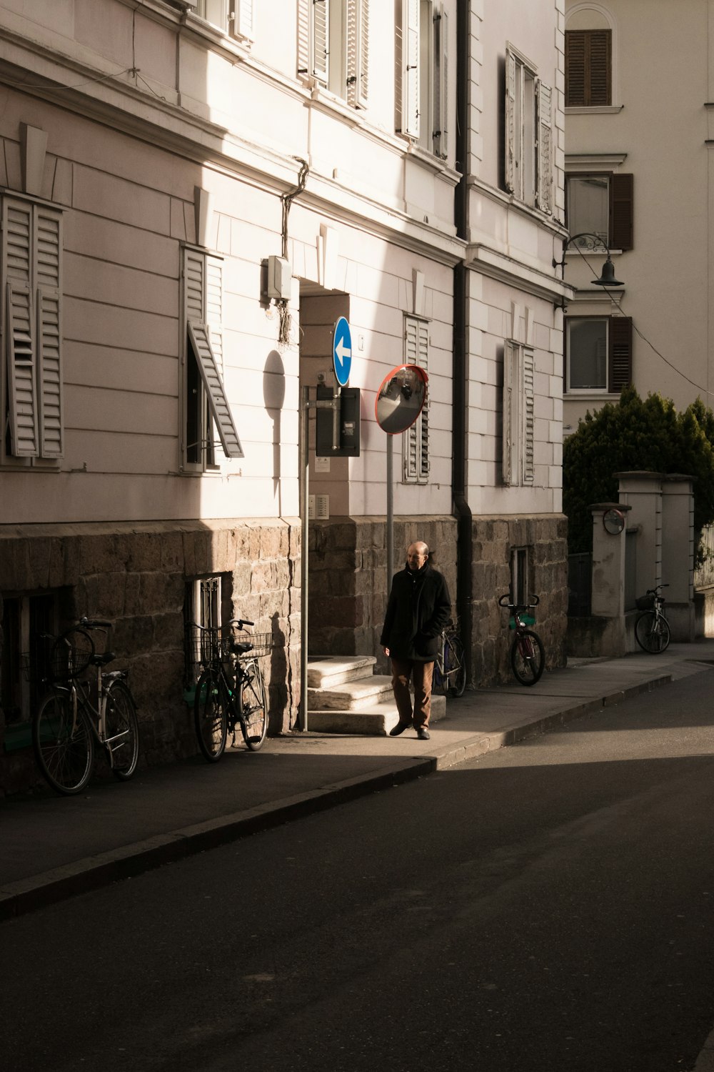 man walking beside building during daytime