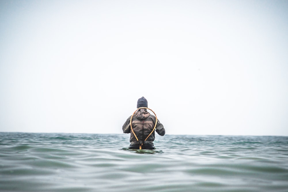 man swimming in sea