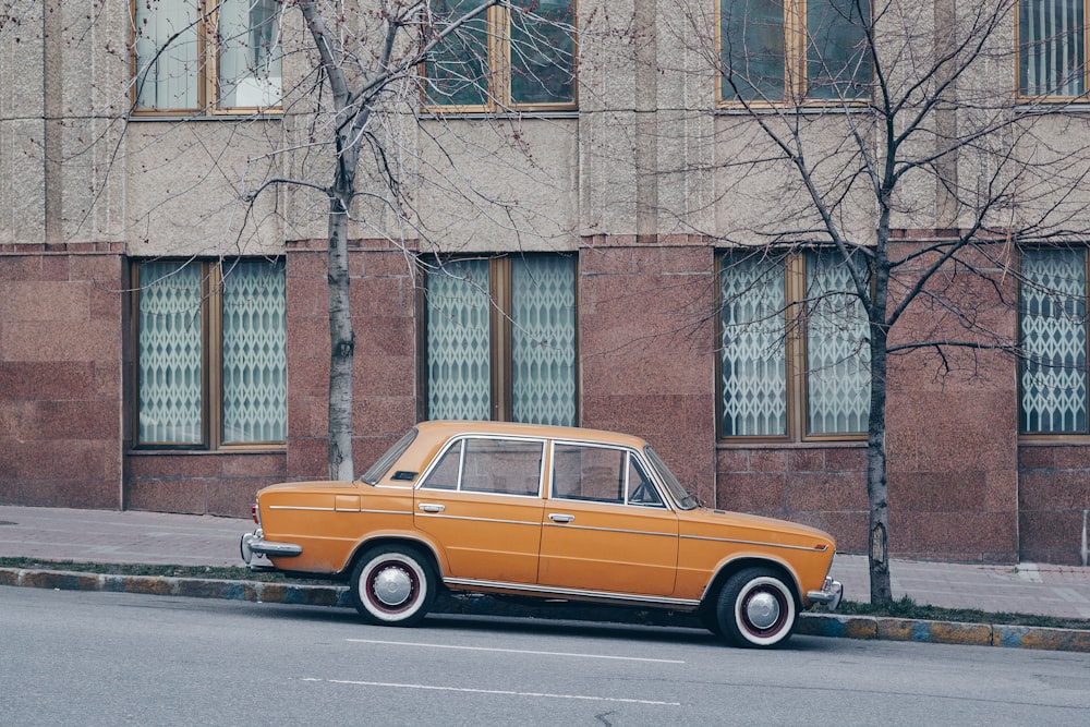 orange sedan on road