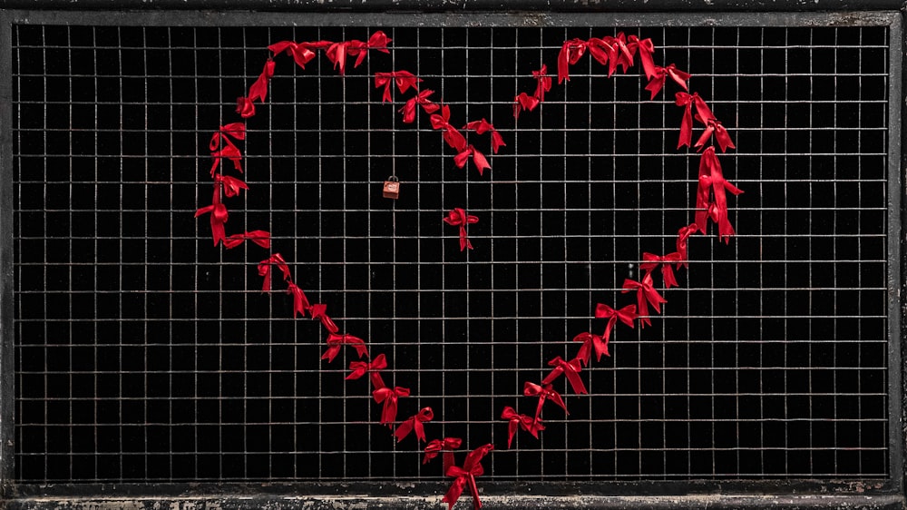 a heart made out of red paper on a black background