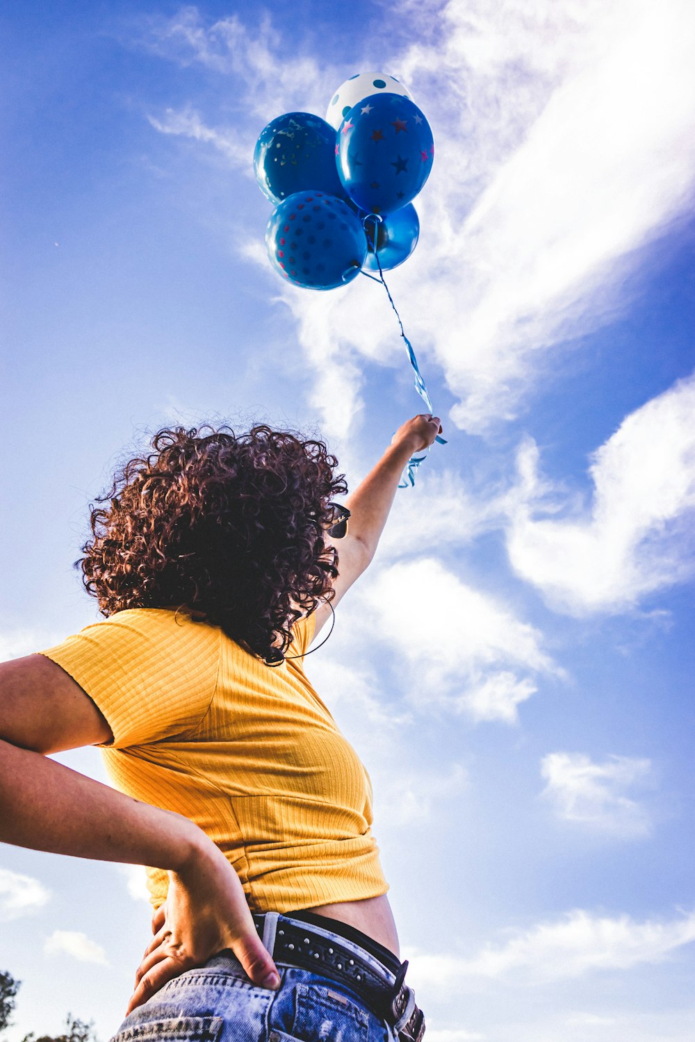 woman holding balloon during daytime