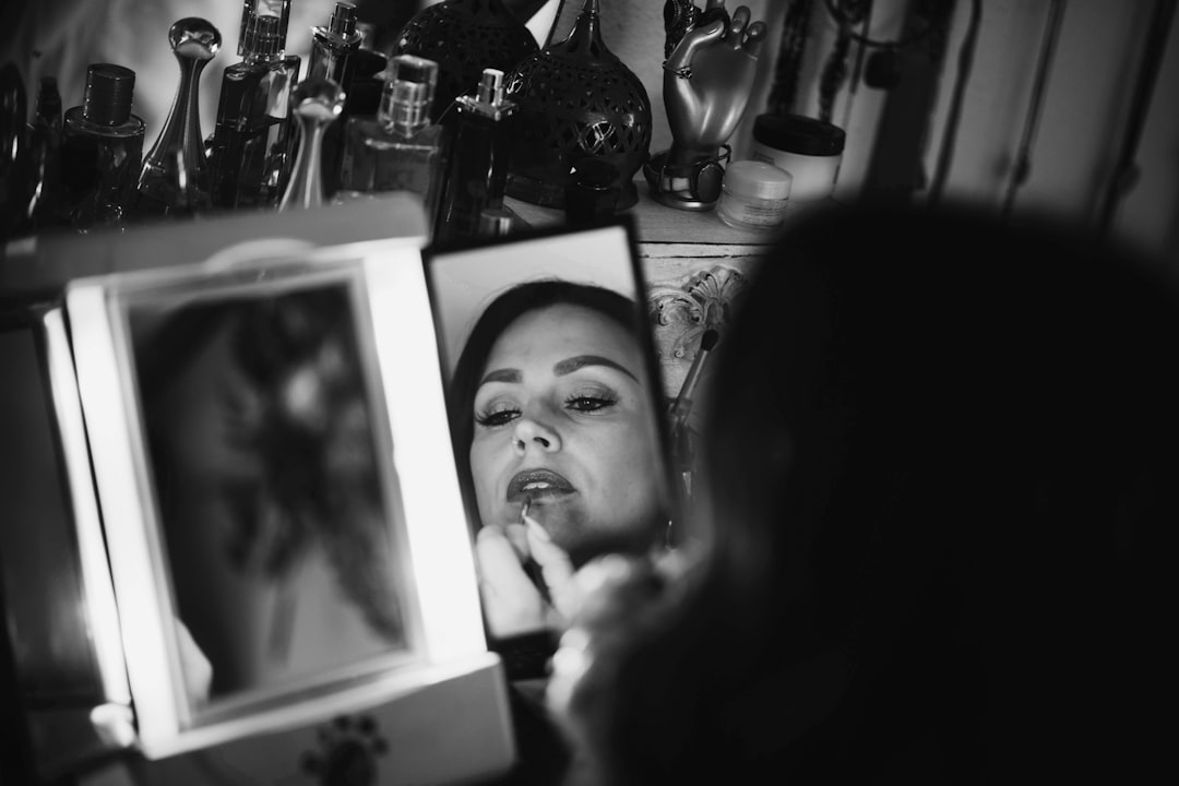 woman looking at herself on the mirror