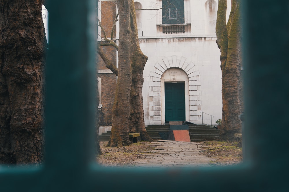 white building with closed green door